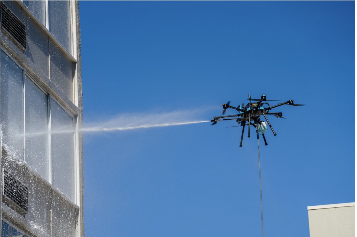 About Vista Drone Cleaning — Lucid Bots Sherpa on a Miami Commercial Building Lucid Bots Sherpa cleaning drone in operation on a Miami commercial building