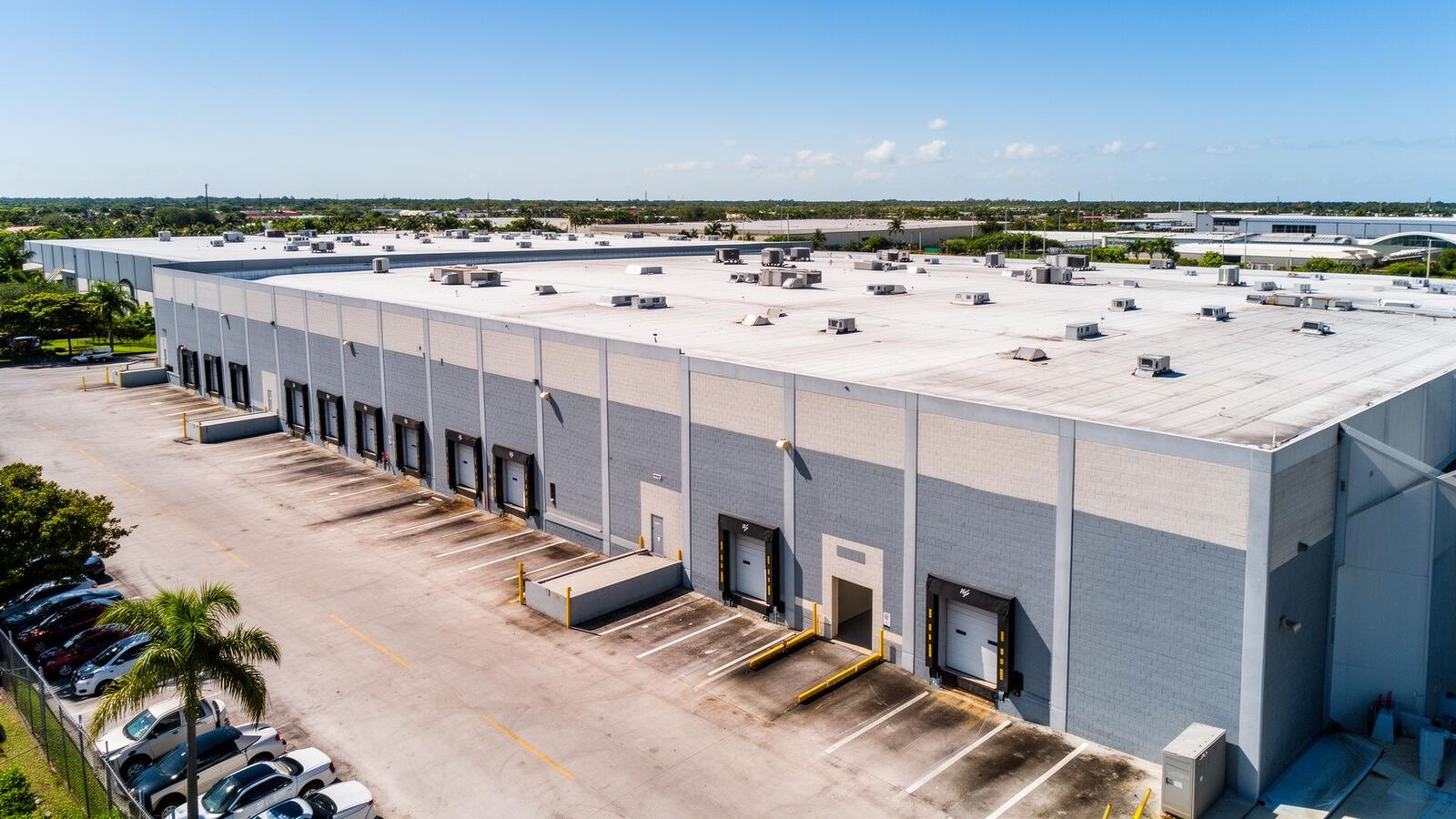 Aerial view of a South Florida warehouse flat roof — the membrane our drones soft-wash with zero foot traffic