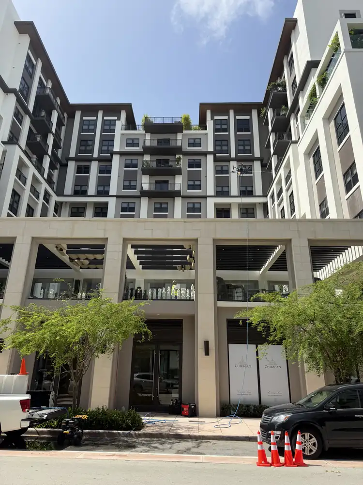 The same Coral Gables assisted living facility after drone soft washing, with facade and balcony surfaces cleaned