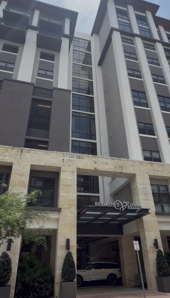Coral stone front entrance of a Coral Gables senior living building before drone facade cleaning