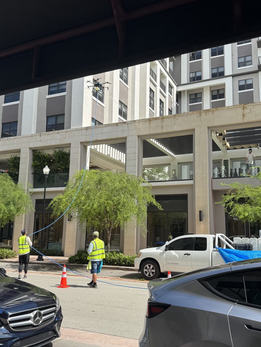 Vista Drone Cleaning crew and truck on site at the Belmont Village high-rise in Coral Gables