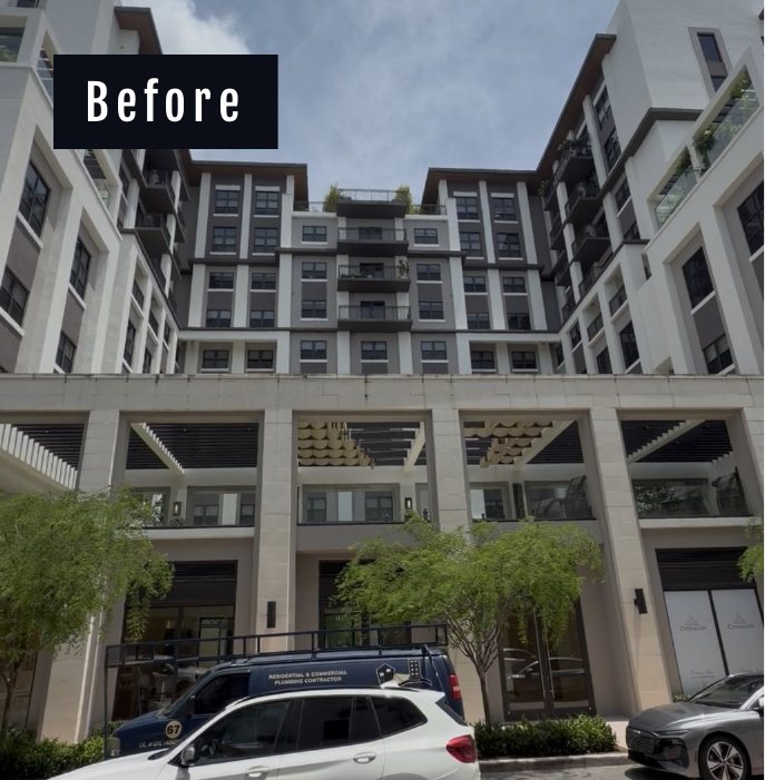 Courtyard facade of Belmont Village in Coral Gables before drone cleaning, dulled stucco above the street