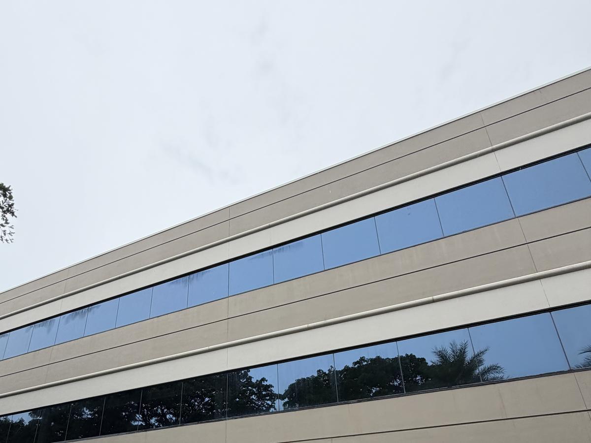 The same window band on the long elevation of Cypress Plaza after cleaning, panels and glass clear