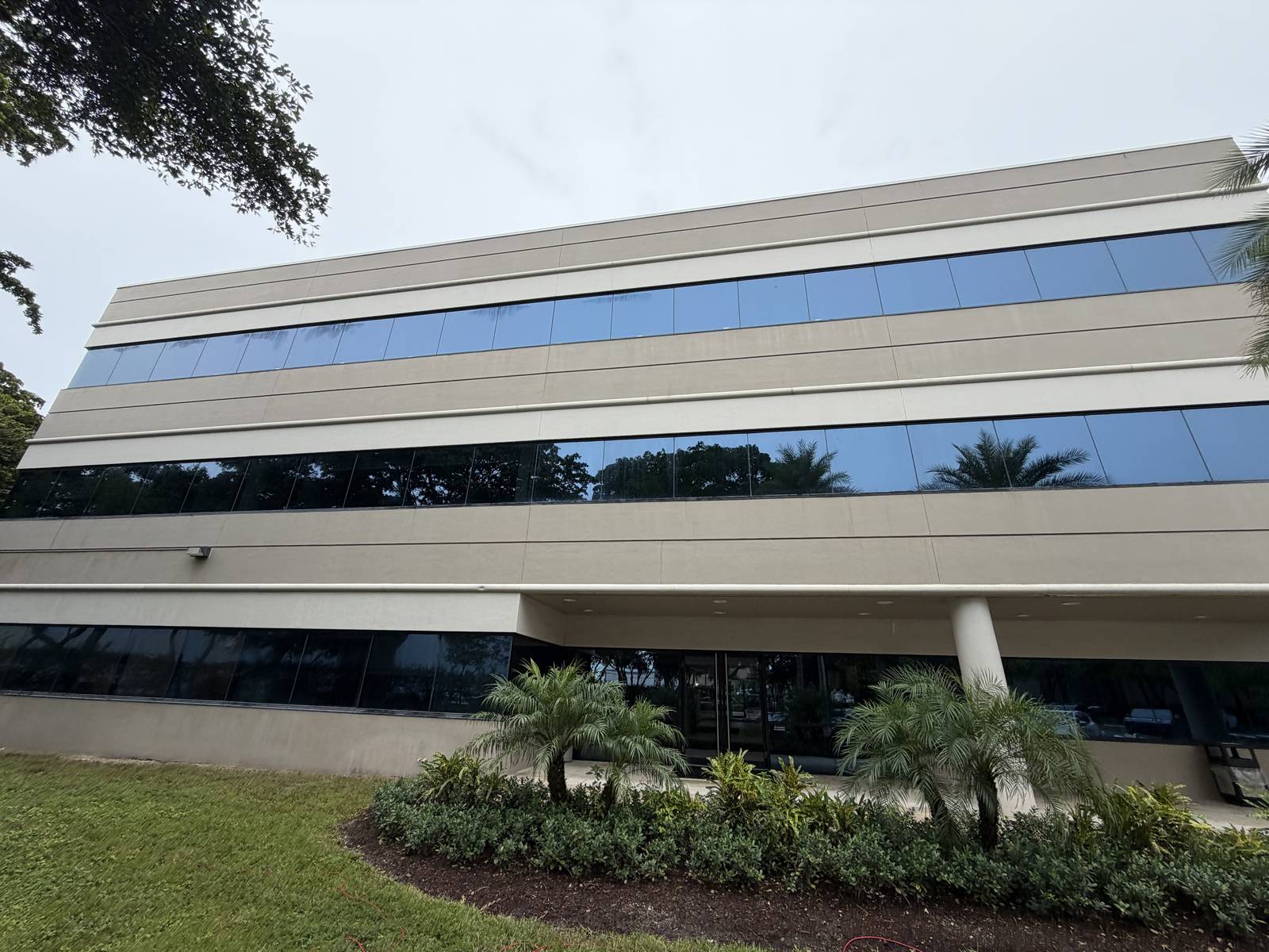 Cypress Plaza in Fort Lauderdale after cleaning, the facade bands and ribbon windows clear of algae
