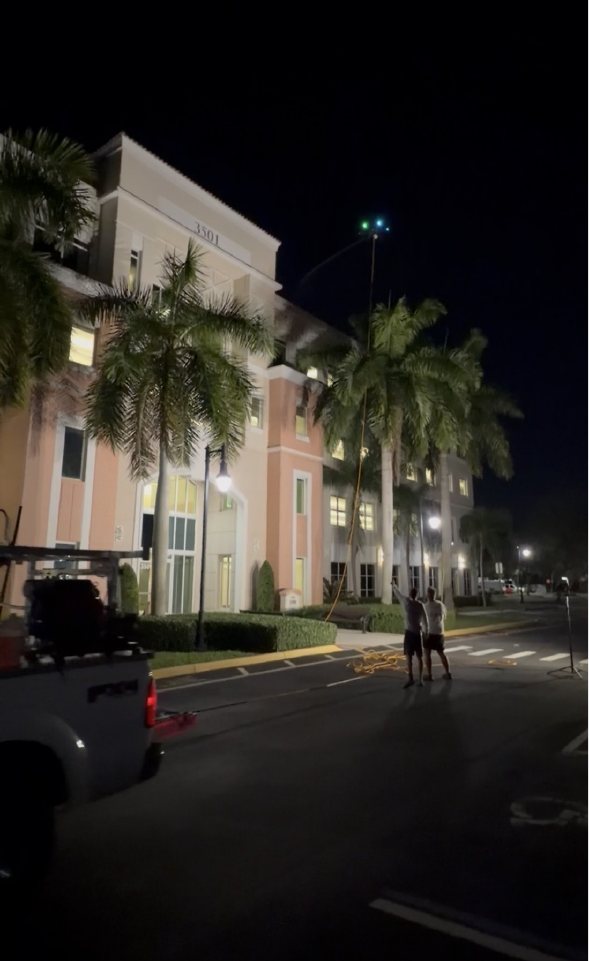 The Vista crew working at Miramar Centre II late at night under the building's lights