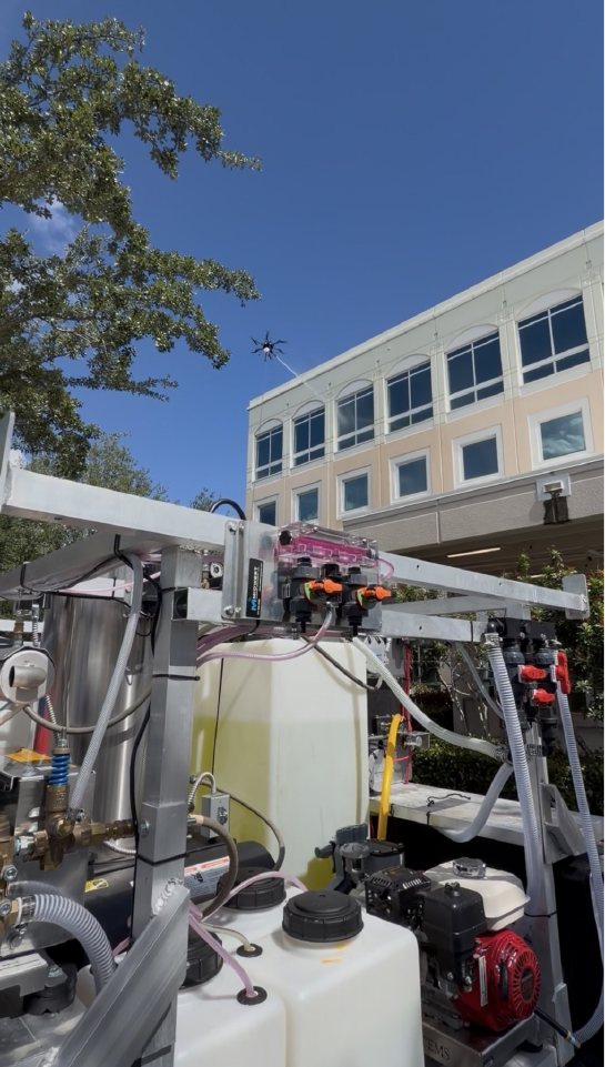 Vista's truck-mounted pump and tank rig in front of Miramar Centre II with the cleaning drone at the facade behind it