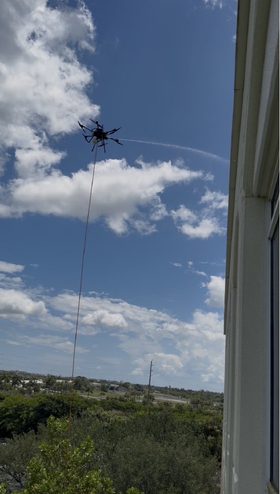 The cleaning drone and its tether seen from a Miramar Centre II window during the wash