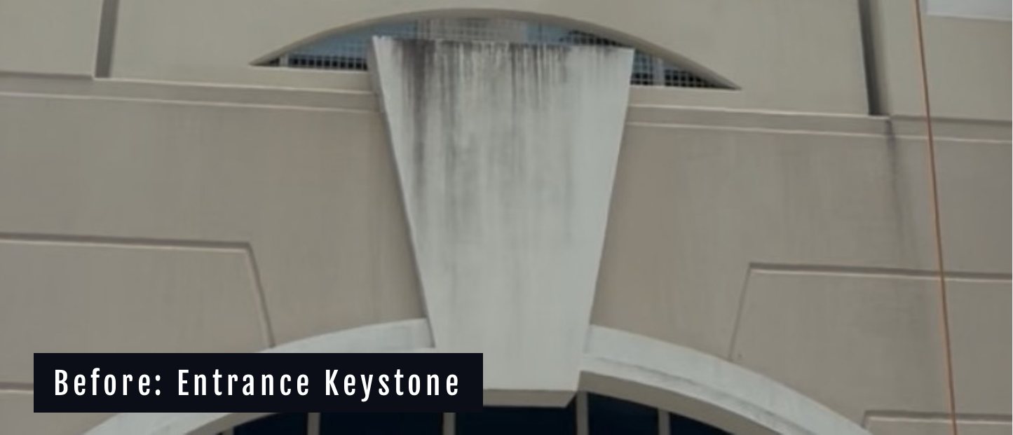 The entrance keystone at Miramar Centre II before cleaning, streaked with runoff staining
