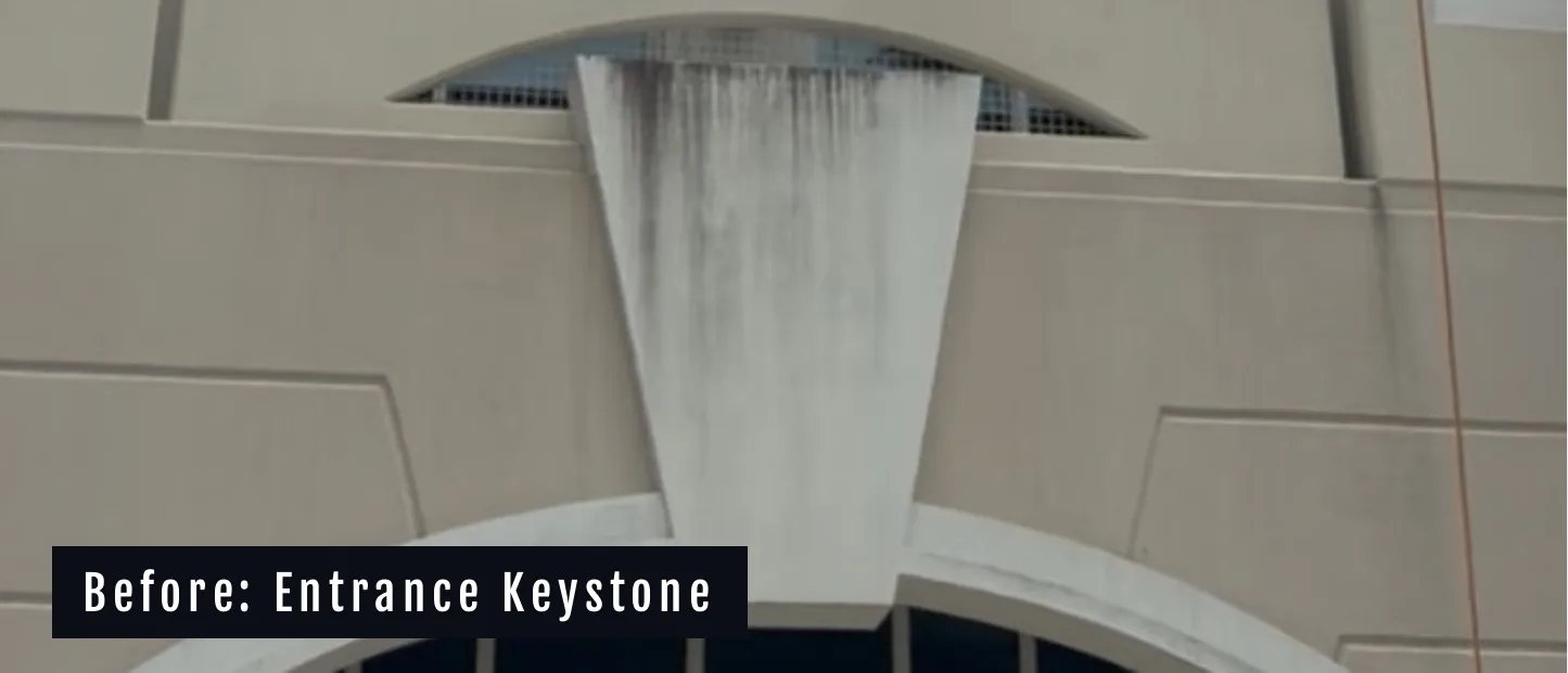 The entrance keystone at Miramar Centre II before cleaning, streaked with runoff staining